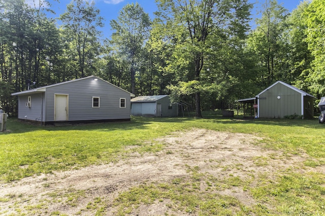 8114 E 72nd St # 2, Newaygo, MI 49337 - view of green lawn with an outbuilding and view of wooded area