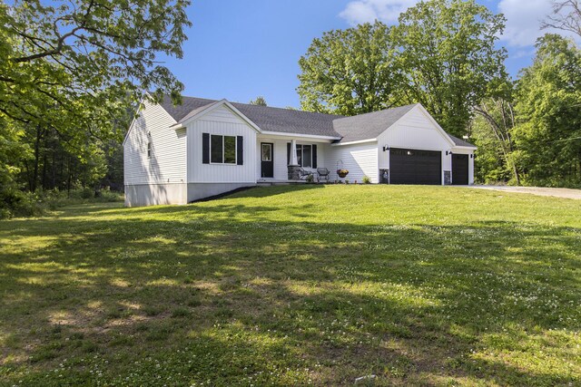 8114 E 72nd St # 2, Newaygo, MI 49337 - view of front of property featuring a garage, a front yard, and driveway