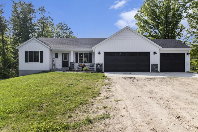 8114 E 72nd St # 2, Newaygo, MI 49337 - view of front of house with driveway, a garage, a front lawn, and a shingled roof