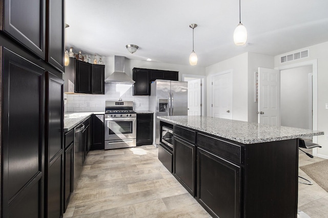 8114 E 72nd St # 2, Newaygo, MI 49337 - kitchen featuring built in appliances, dark cabinetry, wall chimney range hood, and a center island