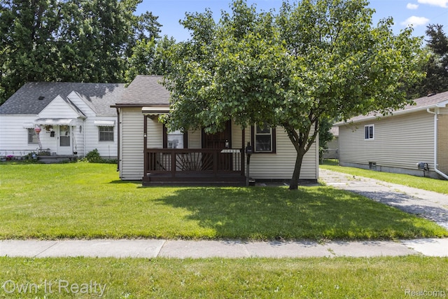 12408 Sarsfield Ave, Clinton Township, MI 48089 - view of front of home with a front yard, roof with shingles, and covered porch