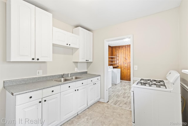 12408 Sarsfield Ave, Clinton Township, MI 48089 - kitchen featuring white gas range oven, washer / clothes dryer, white cabinets, and light countertops