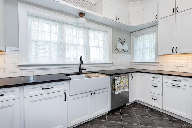 820 N Johnson St, Bay City, MI 48708 - kitchen with stainless steel dishwasher, healthy amount of natural light, dark countertops, and white cabinets
