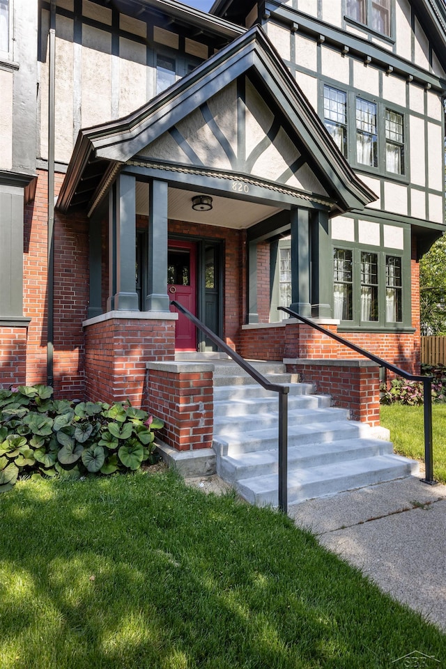 820 N Johnson St, Bay City, MI 48708 - doorway to property with brick siding and a yard