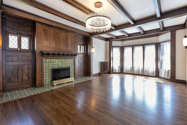 820 N Johnson St, Bay City, MI 48708 - unfurnished living room featuring wood finished floors, beamed ceiling, a chandelier, a fireplace, and coffered ceiling