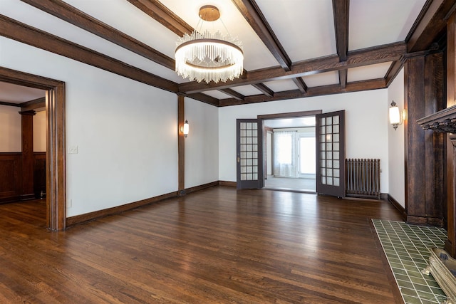 820 N Johnson St, Bay City, MI 48708 - spare room featuring radiator heating unit, a chandelier, wood finished floors, and beamed ceiling