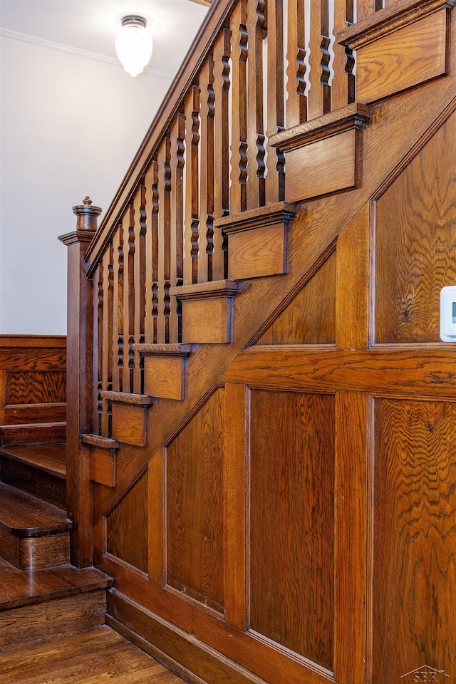 820 N Johnson St, Bay City, MI 48708 - stairs with wooden walls, wood finished floors, and crown molding