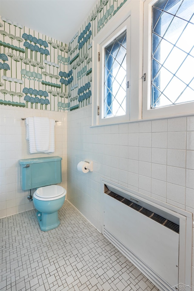 820 N Johnson St, Bay City, MI 48708 - bathroom featuring tile walls, plenty of natural light, and radiator
