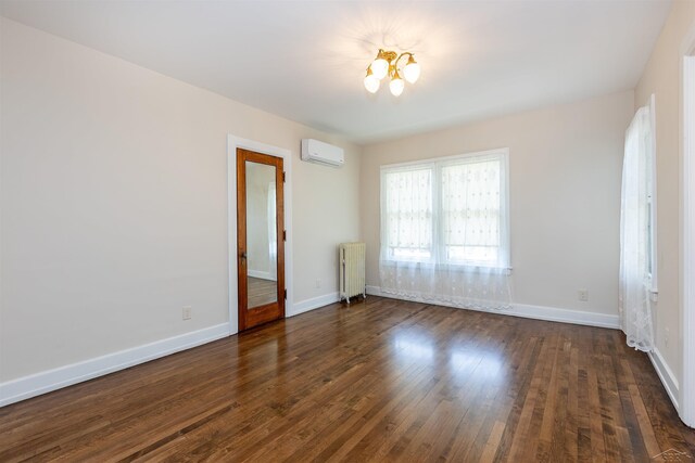 820 N Johnson St, Bay City, MI 48708 - empty room featuring radiator heating unit, a wall unit AC, a chandelier, and dark wood-type flooring