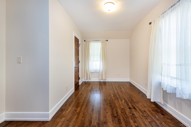 820 N Johnson St, Bay City, MI 48708 - spare room with dark wood-type flooring and baseboards