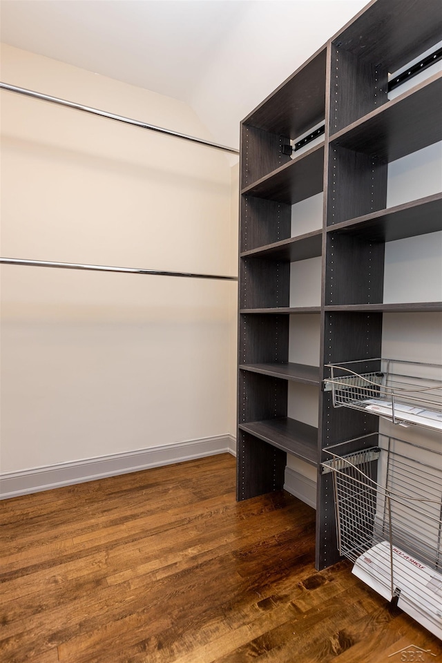 820 N Johnson St, Bay City, MI 48708 - spacious closet featuring dark wood-style flooring and lofted ceiling