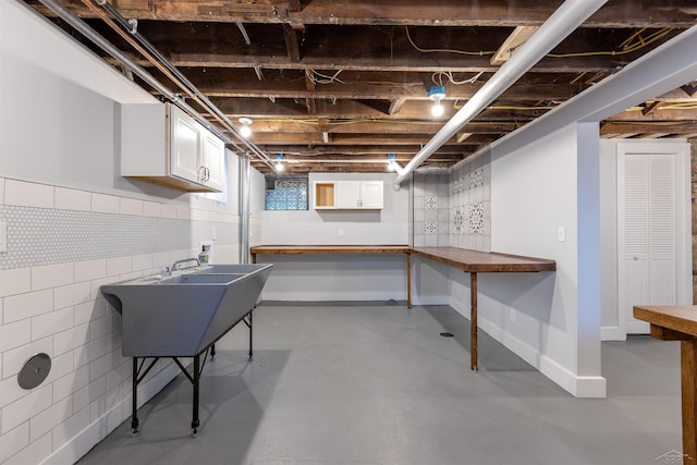 820 N Johnson St, Bay City, MI 48708 - basement with baseboards and a sink