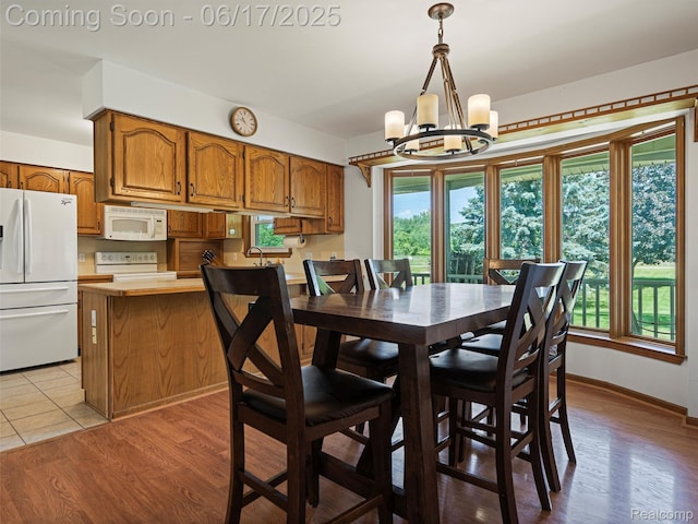 2520 Chilson Meadows Ln, Howell, MI 48843 - dining room with a chandelier and wood finished floors