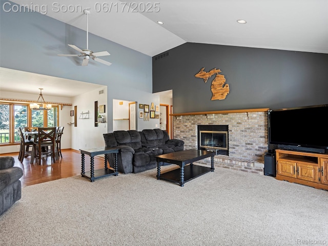 2520 Chilson Meadows Ln, Howell, MI 48843 - living area with carpet floors, high vaulted ceiling, a ceiling fan, a fireplace, and a chandelier