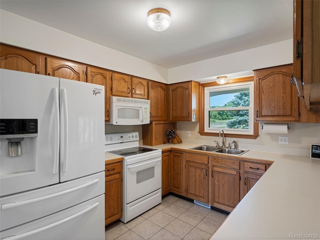2520 Chilson Meadows Ln, Howell, MI 48843 - kitchen featuring white appliances, light countertops, brown cabinetry, and light tile patterned floors