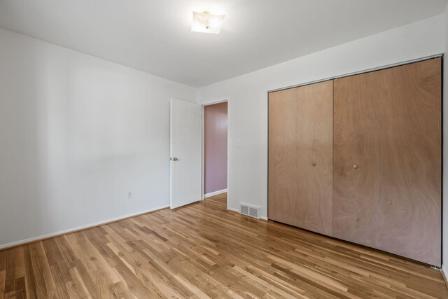 2850 Sherbourne Dr, Troy, MI 48083 - unfurnished bedroom with light wood finished floors and a closet