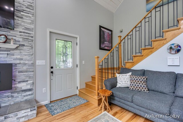 5980 Division St, Newaygo, MI 49337 - entrance foyer featuring wood finished floors, stairs, and high vaulted ceiling