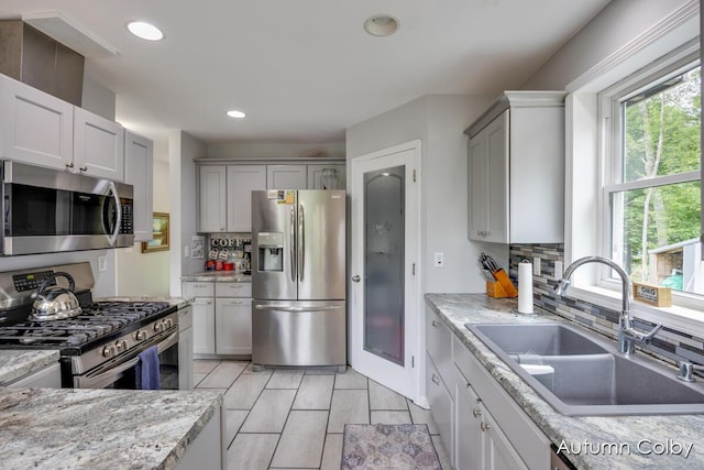 5980 Division St, Newaygo, MI 49337 - kitchen featuring appliances with stainless steel finishes, backsplash, recessed lighting, and gray cabinetry