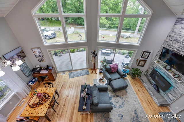 5980 Division St, Newaygo, MI 49337 - living area with healthy amount of natural light, a towering ceiling, a fireplace, and wood finished floors