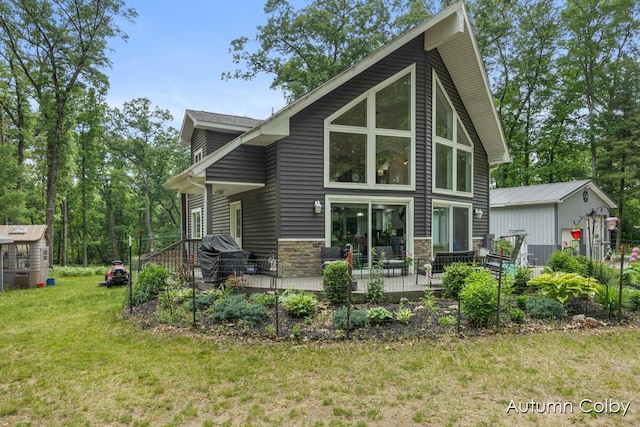 5980 Division St, Newaygo, MI 49337 - rear view of house featuring a lawn, stone siding, and an outdoor structure