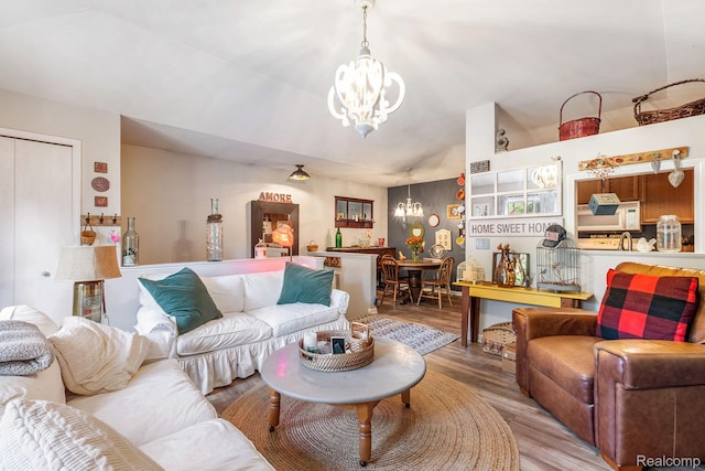 4022 Stonebridge, Holly, MI 48442 - living area with a chandelier, wood finished floors, and lofted ceiling