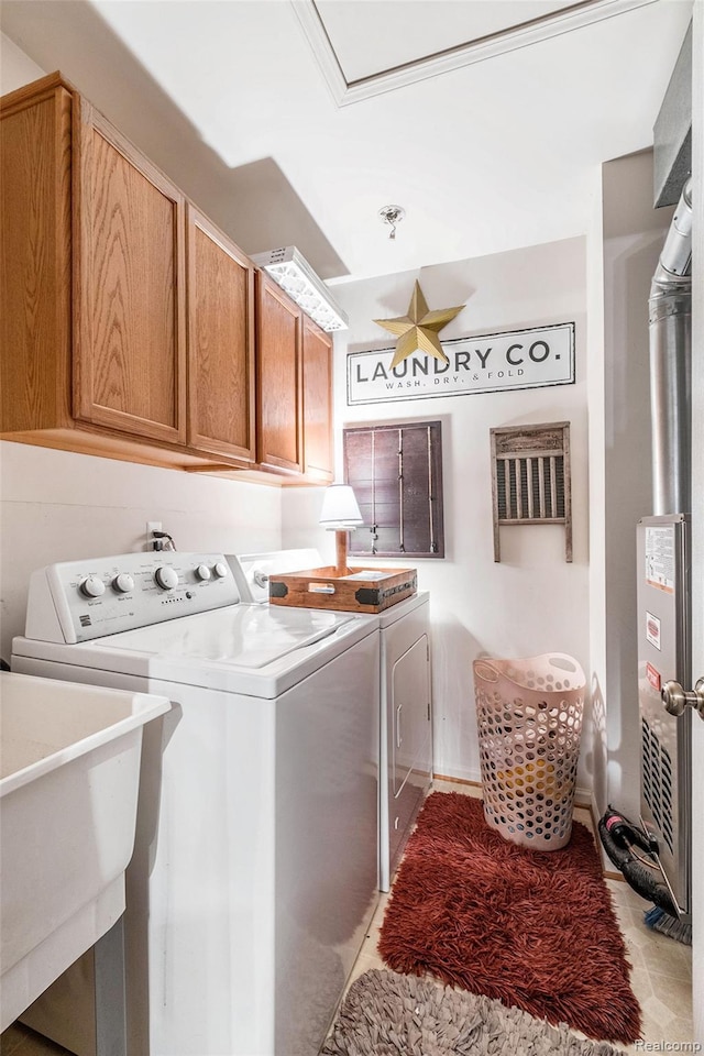 4022 Stonebridge, Holly, MI 48442 - washroom featuring separate washer and dryer, cabinet space, and light tile patterned floors