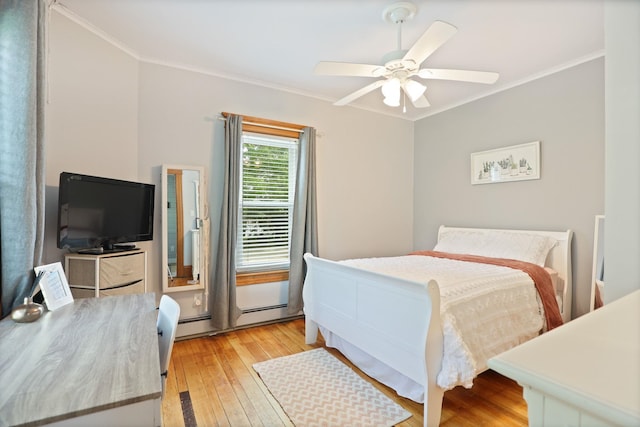 1105 W Genesee St, Frankenmuth, MI 48734 - bedroom featuring ornamental molding, light wood-style flooring, a ceiling fan, and a baseboard radiator