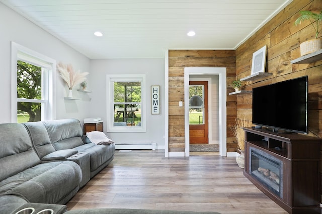 1105 W Genesee St, Frankenmuth, MI 48734 - living room featuring wooden walls, plenty of natural light, recessed lighting, wood finished floors, and baseboard heating