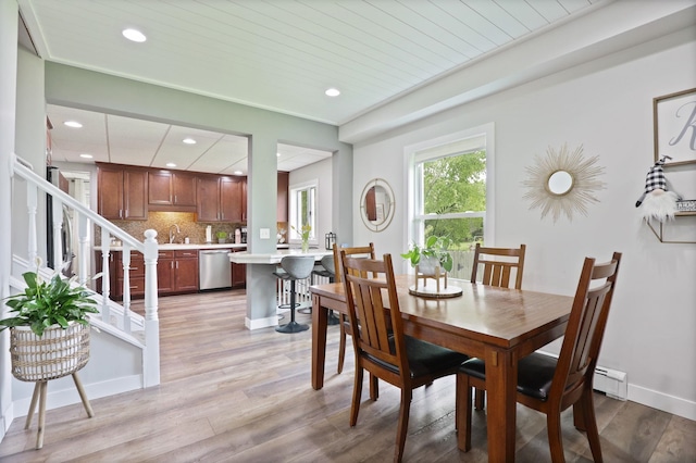 1105 W Genesee St, Frankenmuth, MI 48734 - dining space featuring recessed lighting, light wood-type flooring, a baseboard heating unit, and stairway