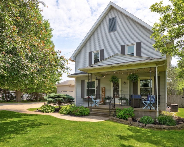 1105 W Genesee St, Frankenmuth, MI 48734 - view of front of house featuring covered porch, a front yard, and a garage