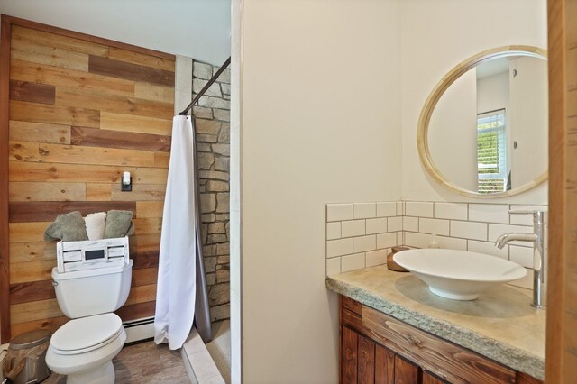 1105 W Genesee St, Frankenmuth, MI 48734 - full bath with decorative backsplash, a baseboard radiator, vanity, a stall shower, and wooden walls