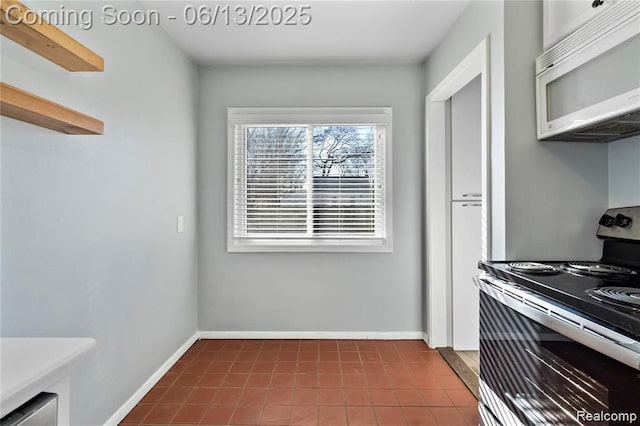 4033 Oakshire Ave, Berkley, MI 48072 - kitchen featuring white microwave, electric stove, and dark tile patterned flooring