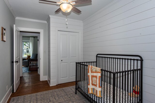 1303 Homecrest Ave, Kalamazoo, MI 49001 - bedroom with wood finished floors, a closet, ornamental molding, a nursery area, and ceiling fan