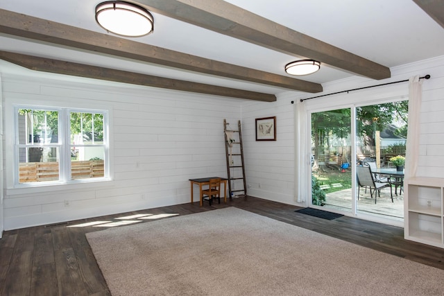 1303 Homecrest Ave, Kalamazoo, MI 49001 - unfurnished living room with beam ceiling, dark wood-type flooring, and wooden walls