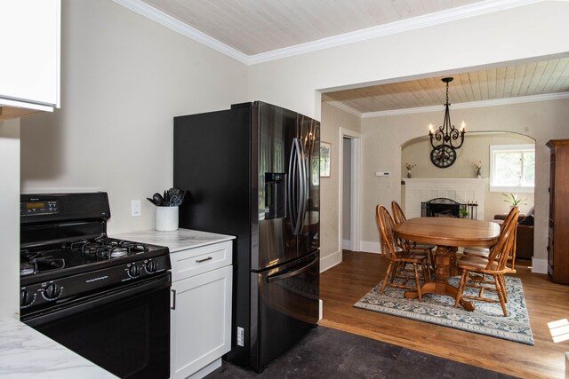 1303 Homecrest Ave, Kalamazoo, MI 49001 - kitchen featuring black appliances, white cabinetry, light countertops, ornamental molding, and dark wood-style floors