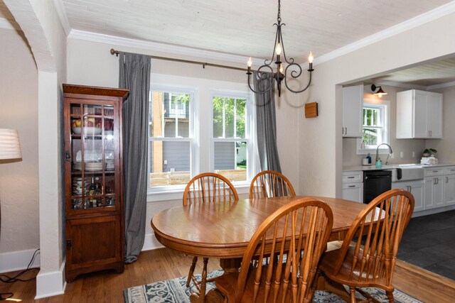 1303 Homecrest Ave, Kalamazoo, MI 49001 - dining room with crown molding, a chandelier, healthy amount of natural light, and light wood finished floors