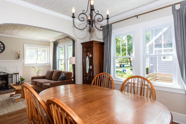 1303 Homecrest Ave, Kalamazoo, MI 49001 - dining area with crown molding, plenty of natural light, dark wood finished floors, arched walkways, and a chandelier