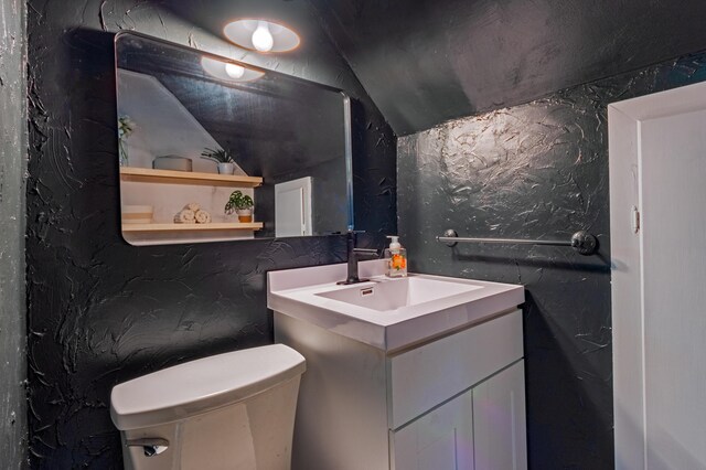 1303 Homecrest Ave, Kalamazoo, MI 49001 - half bath featuring vanity and vaulted ceiling