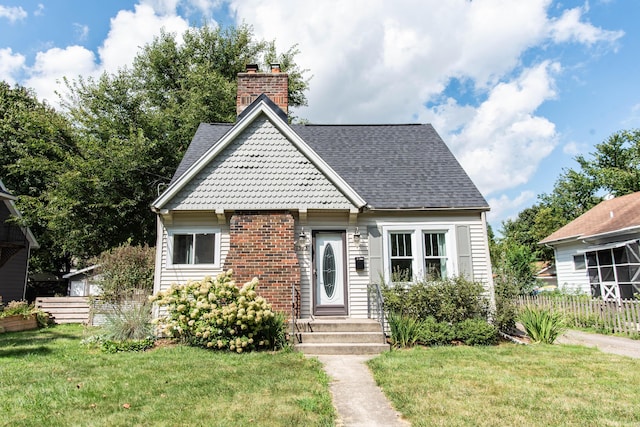 1303 Homecrest Ave, Kalamazoo, MI 49001 - view of front facade featuring a chimney, roof with shingles, and brick siding