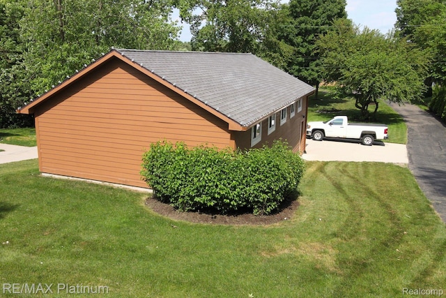 2757 S Hacker Rd, Brighton, MI 48114 - view of side of home with a yard and a shingled roof