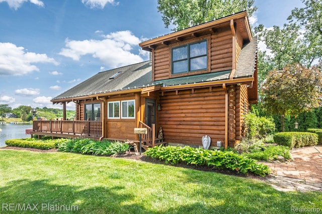 2757 S Hacker Rd, Brighton, MI 48114 - log home featuring log siding, a deck with water view, and a front yard