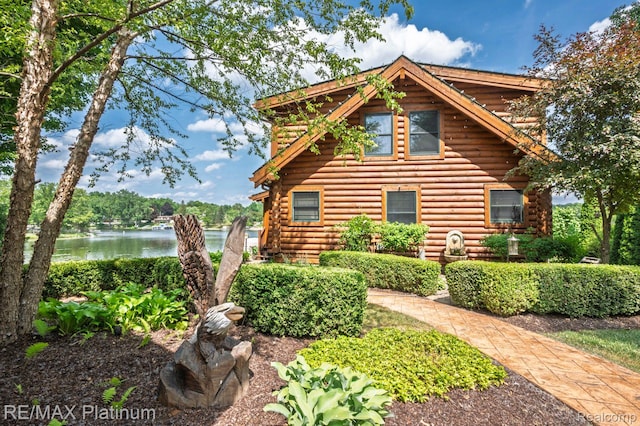 2757 S Hacker Rd, Brighton, MI 48114 - view of front facade featuring log exterior and a water view