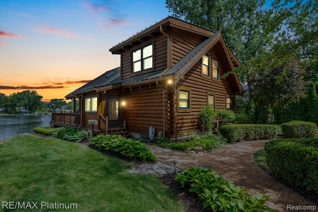 2757 S Hacker Rd, Brighton, MI 48114 - view of home's exterior with a lawn, a water view, and log siding