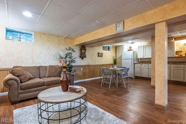 2757 S Hacker Rd, Brighton, MI 48114 - living room featuring a paneled ceiling, wainscoting, and wood finished floors