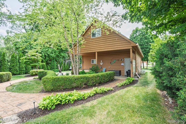 2757 S Hacker Rd, Brighton, MI 48114 - rear view of house with log veneer siding and a yard