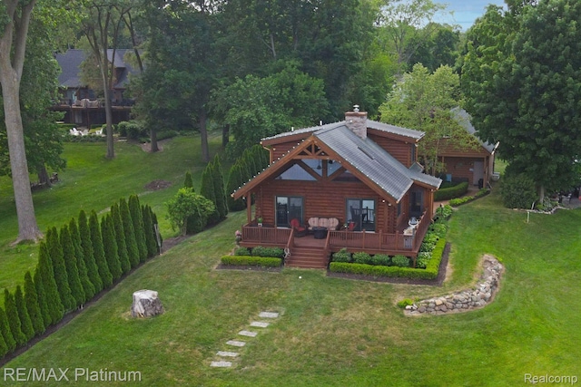 2757 S Hacker Rd, Brighton, MI 48114 - view of front facade with a chimney, a deck, and log siding