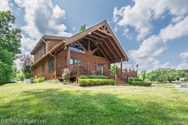 2757 S Hacker Rd, Brighton, MI 48114 - back of house with log siding, a lawn, a wooden deck, and stairway