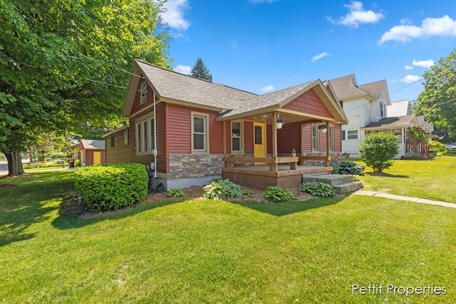 340 E Main St SE, Caledonia, MI 49316 - view of front of house with a front yard, covered porch, and roof with shingles
