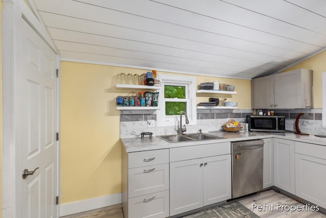 340 E Main St SE, Caledonia, MI 49316 - kitchen featuring appliances with stainless steel finishes, open shelves, light wood-type flooring, backsplash, and light countertops