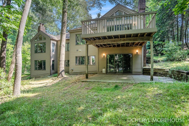 6555 Waybridge Dr SE, Grand Rapids, MI 49546 - back of property with a chimney, a patio area, a lawn, and a wooden deck